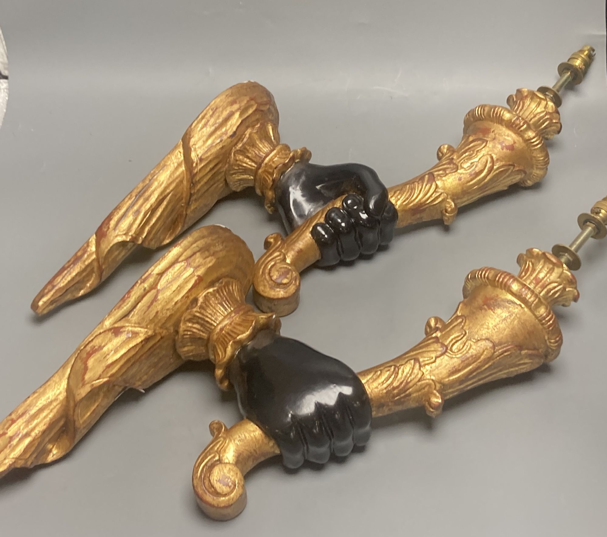 A pair of gilt and ebonised carved wood hand and cornucopia wall sconces, height 52cm not including light fitting